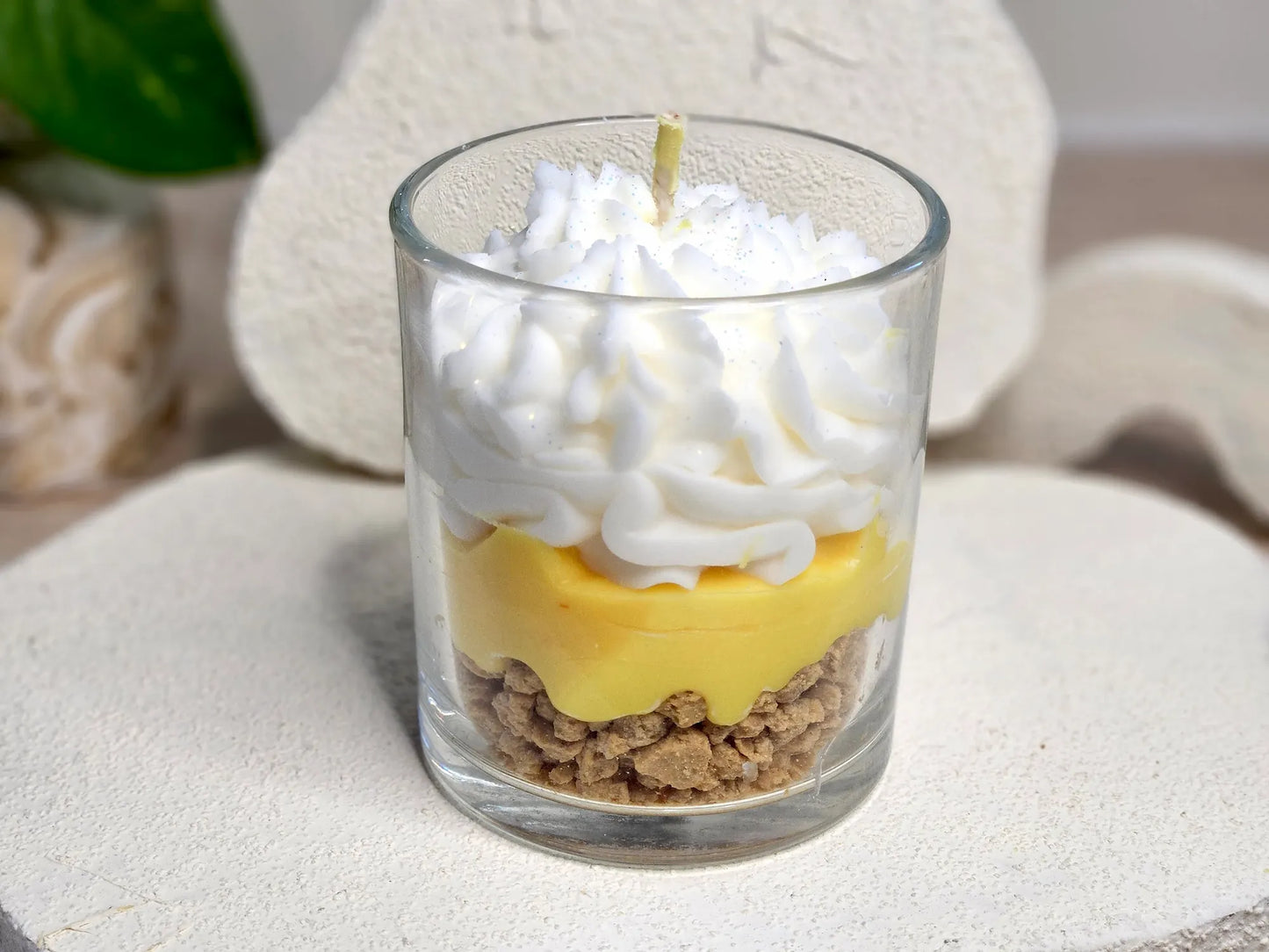 Vue arrière montrant les trois couches de la bougie citron meringué : crumble croustillant, crème acidulée et meringue onctueuse.